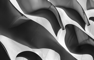 Aufkleber - A black and white photograph of a curving, abstract structure.