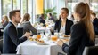 © KHF - Sophisticated business networking breakfast with professionals conversing over a stylishly arranged table.