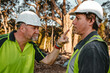 © Austockphoto - Two building contractors in a heated argument at the construction site.