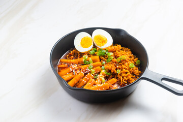 Korean instant noodles with Korean rice cake and fish cake and boiled egg - Rabokki - Korean food style. Perfect for recipe, article, catalogue, commercial, or any cooking content.