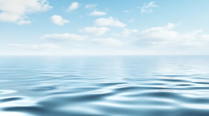 Calm, blue ocean water with a light blue sky and white clouds.