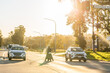 © Austockphoto - Golden light over traffic at intersection with motorcyclist