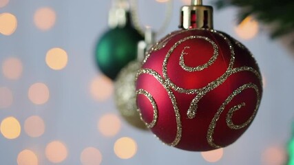 Wall Mural - Christmas tree decorated with red ball on pine branches with bokeh light background
