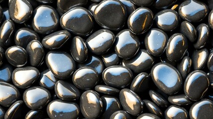 black shiny pebbles flat surface texture background