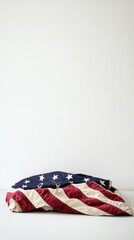 Folded American flag on a clean, minimalistic background. A symbol of respect and remembrance for veterans.