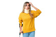 © luismolinero - Young Uruguayan woman wearing neck brace and crutches over isolated background having doubts and with confuse face expression