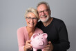 © luismolinero - Middle aged couple holding a piggybank