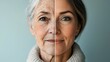 © Morng - Split view showing the aging process with one side of the face young and the other old, representing youth versus aging concept.