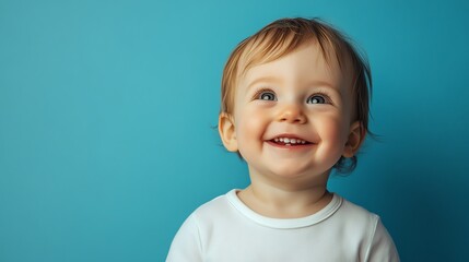 Poster - A baby girl with blonde hair smiles brightly.