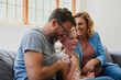 © Sanc/peopleimages.com - Happy family, laughing and playing with daughter on sofa for bonding, holiday or fun weekend together at home. Mother, father and child or kid with smile for funny childhood, love or support at house