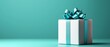 © Wall - A white gift box, adorned with a blue ribbon and bow atop, situated against a teal backdrop