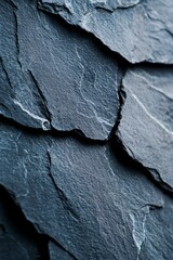 Wall Mural -  A tight shot of a black slate wall featuring a tiny white object situated in one of its corners