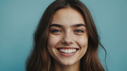 teenage european woman on pastel blue background model close-up smiling with beautiful teeth for ad concept space for text