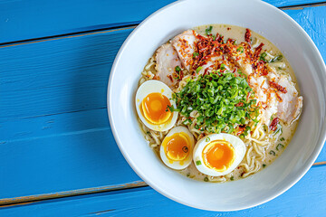 a delectable ramen dish with a rich, savory broth and soft-boiled eggs, artfully arranged on a blue wooden table