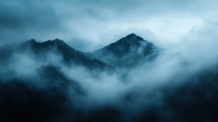 A dramatic landscape with mist-covered mountains creates a moody and atmospheric view that engulfs the dense forest below, evoking mystery and calmness.