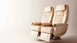 © padungsak - Two luxury airplane seats with beige upholstery, isolated on a light background.