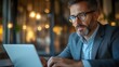 © ZpongXED - Closeup of a manager analyzing resource management software on a laptop