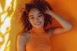 © Vlad - Smiling Woman in Orange Top against Bright Orange Background