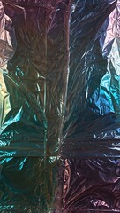 Wall Mural - Transparent crinkled plastic wrap texture with iridescent light patterns.