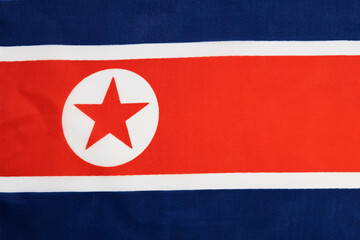 national flag of the state of north korea close-up. state background.