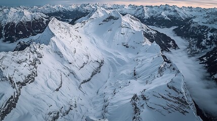 Wall Mural -   An aerial shot of snow-capped mountains with cloud coverage