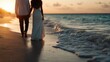 © JoxyAimages - A wedding couple, elegantly dressed, holds hands and walks along the shore at sunset, capturing a beautiful and intimate moment against the scenic ocean backdrop.