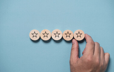 Poster - Hand input five stars on wooden block and blue background for the best customer satisfaction and evaluation for good quality product and service.