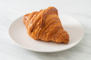 fresh croissant on white plate