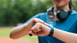 © Dee karen - Young woman checking her wristwatch via app to measure her heart rate. Healthy exercise concept. Running, walking.