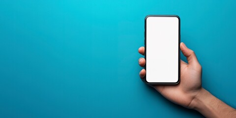 Hand holding a smartphone with a blank white screen against a blue background, offering a clear display for a mockup or app presentation.