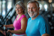 © huntspy - A smiling senior man and woman are working out together on treadmills, showcasing their joy and commitment to fitness. Their positive energy is inspiring and uplifting