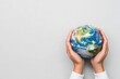© Natalia - Close-up of hands holding a globe, symbolizing global corporate responsibility and commitment to positive environmental impact Global responsibility, Environmental CSR