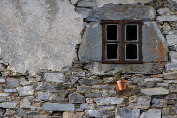 weathered charm old stone building with wooden shutters and forgotten pot.