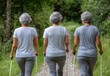 © munawaroh - Three older women walking on a nature path with walking sticks.