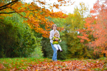 Wall Mural - Kids playing in autumn park