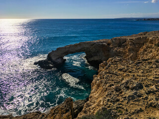 Love bridge near Ayia Napa in Cyprus. Natural rock arch Bridge of Lovers at Cape Greco. Sea caves on coastline between Agia Napa and Cavo Greco National park