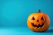 © Minerva Studio - Halloween pumpkin smiling on a blue background
