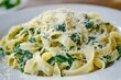 © Minerva Studio - Steaming hot plate of tagliatelle pasta with spinach and cheese