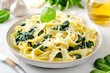 © Minerva Studio - Fettuccine pasta with spinach and grated cheese on white plate