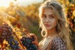© Minerva Studio - Young woman harvesting grapes in vineyard at sunset
