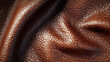 © Elnare - Close-up texture of brown leather with a pebbled surface.