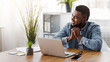 © Prostock-studio - Pensive black entrepreneur dreaming about something while working in modern office, copy space