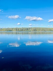 Poster - beautiful blue lake view, blue sky with white clouds reflections on the lake surface