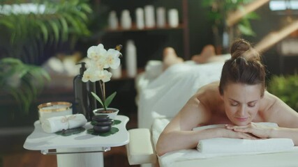 Poster - Healthcare time. relaxed modern middle aged woman in massage cabinet laying on massage table.