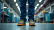 © abu - Low angle of factory worker in safety boots, highlighting professionalism and industry.