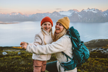 mother and child daughter laughing having fun outdoor family hiking together travel lifestyle active
