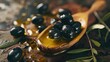 © TheWaterMeloonProjec - Black pickled olives infused with fragrant herbs and olive leaves placed on a wooden spoon, accompanied by splattered pristine olive oil.