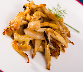 Wall Mural - Homemade roasted agaric honey mushrooms with onions on white plate