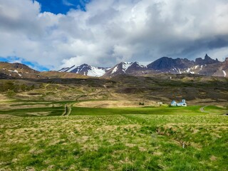 Wall Mural - Scenic Icelandic landscape with blue house and snow-capped mountains