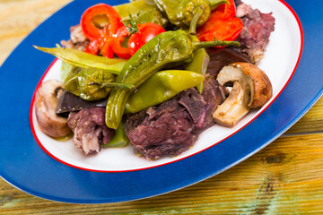 Delicate mutton stewed in red wine with aubergine, pepper, green beans and champignons..